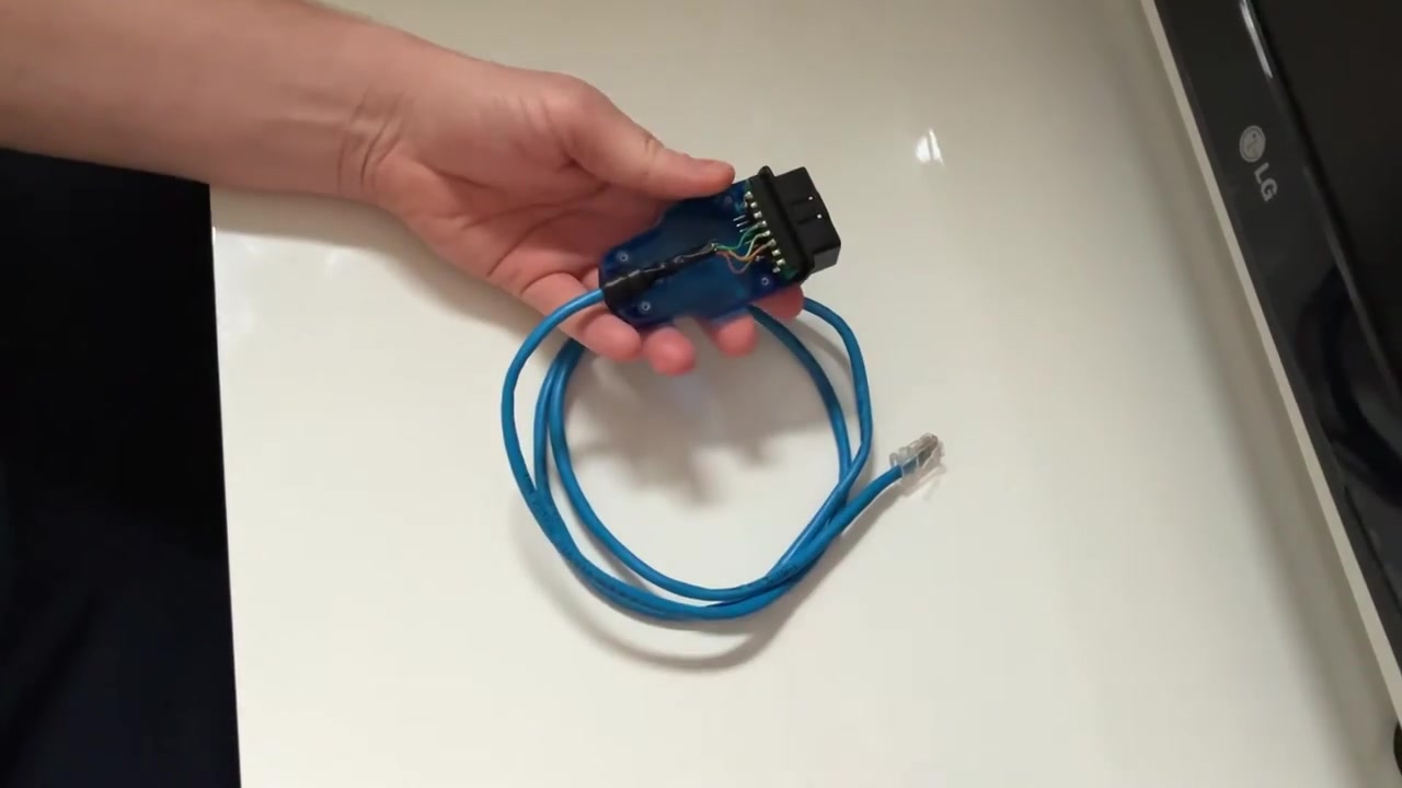 Close-up of the custom-made DoIP cable, showing the internal wiring connecting the RJ45 cable to the OBD-II connector.