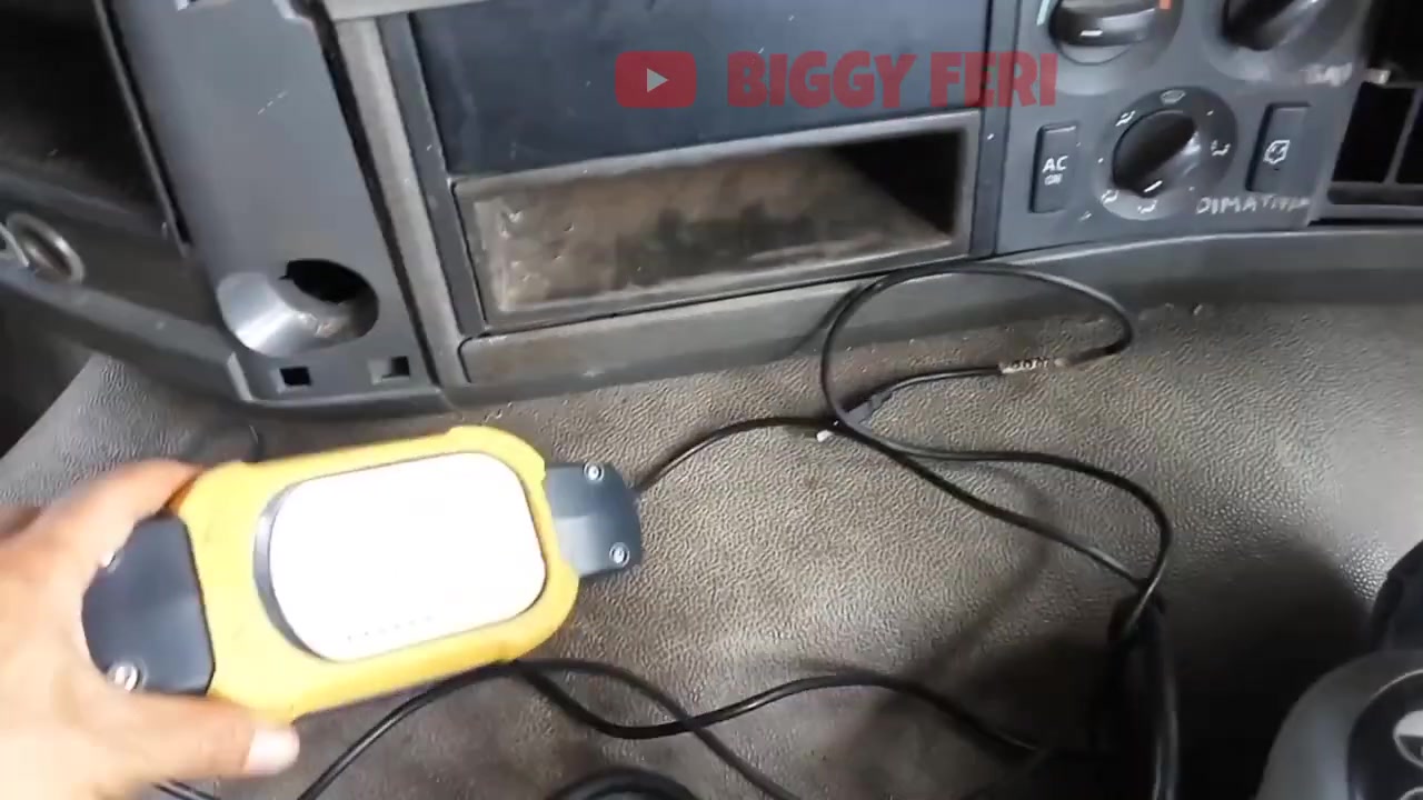 VOCOM diagnostic tool connected inside the truck cabin.