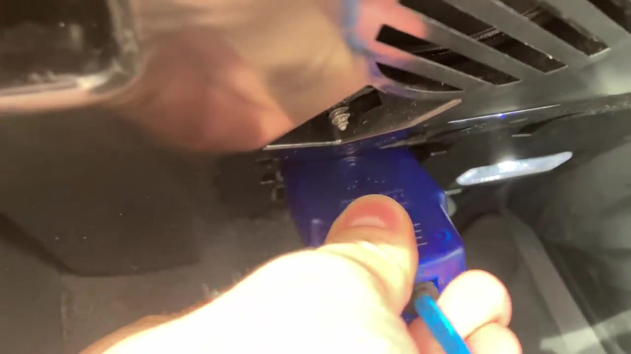 Connecting the custom DoIP cable to the car's OBD-II port, located under the dashboard.