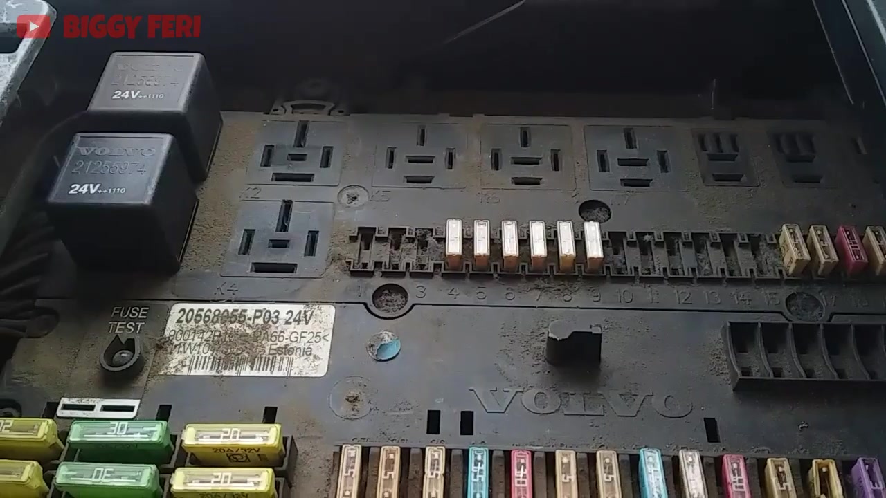 Close-up of a vehicle fuse box, with a finger pointing to fuse #5 (instrument panel fuse) before removal.