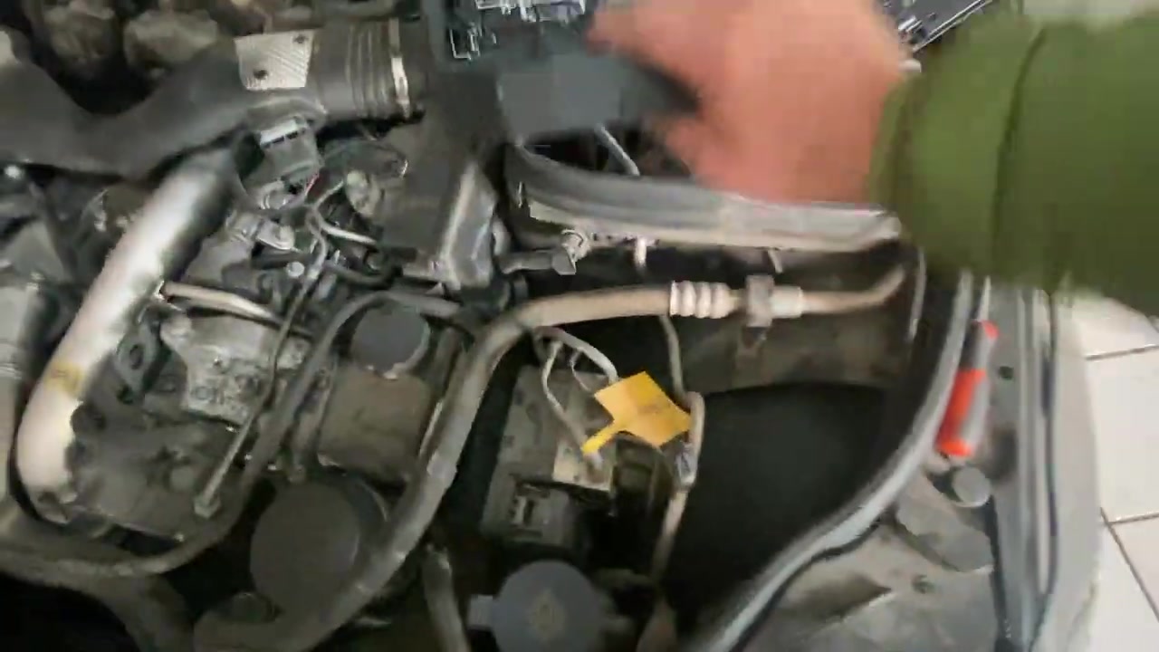 Close-up of the damaged SAM module (fuse box) under the hood, showing water damage and exposed connectors.